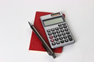 black and silver calculator beside black pen by Recha Oktaviani courtesy of Unsplash.