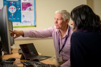 a man pointing at a woman by Centre for Ageing Better courtesy of Unsplash.